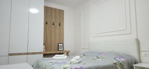 a bedroom with a bed with towels on it at Helianthus, by Bloom Apartments in Central Tirana in Tirana