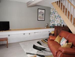 BadensL'ancienne écurie, near Carcassonne, private and charming accomodation Corporate bookings accepted的带沙发和电视的客厅
