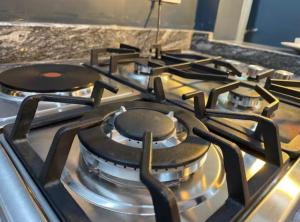 a group of burners on a stove in a kitchen at Beverly homes Entebbe in Kitubulu +9 photos