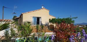 a house with a bunch of plants in front of it at Villa Palmera - Classée 3 étoiles - Grand confort, calme, et magnifique vue dégagée in Canet +26 photos
