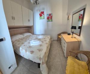 a small bedroom with a bed and a table at Casa Aurora in Polignano a Mare