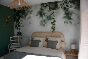 a bedroom with a bed with leaves on the wall at Le Bonheur à Ventoux in Saint-Pierre-de-Vassols
