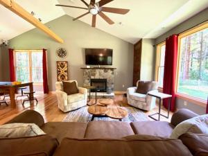 a living room with a couch and a fireplace at Evergreen - by The Chalets in Laurelville +26 photos