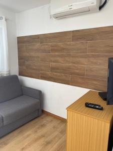 a living room with a couch and a tv at Campimeco by Campigir in Alfarim