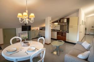 a living room with a table and a couch at La Mansarda Dell'Ulivo in Santa Maria degli Angeli +17 photos