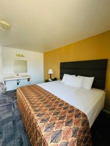 a hotel room with a large bed and a desk at Americas Best Value Inn Salmon in Salmon +27 photos