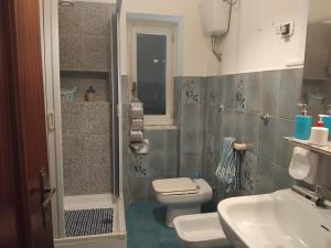 a bathroom with a toilet and a sink and a shower at La capannina cilento cam 12 in San Marco di Castellabate +58 photos