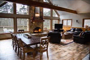 a living room with a table and a fireplace at Fireside Lodge - by The Chalets in Logan +35 photos