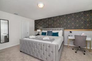 a bedroom with a bed with a desk and a chair at Luxurious Townhome in Solterra Resort - SOLT01 in Davenport +41 photos
