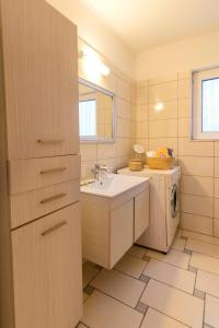 Un baño con lavabo y lavadora. en Central House of Ialisos, en Ialisos 28 fotos más