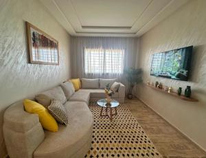 a living room with a couch and a table at Cosy Stay 15min from Casablanca Airport, in Berrechid in Berrechid