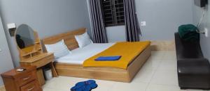 a small bedroom with a bed and a mirror at Nhà nghỉ 79 in Ngô Xa