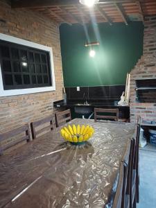 a bunch of bananas on a table in a room at Areia Green in Areia