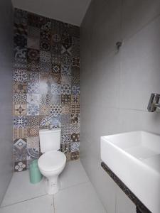 a bathroom with a toilet and a sink at Areia Green in Areia +14 photos