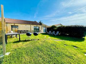 two barbecue stools in the yard of a house at Les Gites de la Richardiere in Saint-Révérend