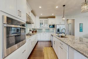 a kitchen with white cabinets and stainless steel appliances at Marlin Chase --- 30347 Bermuda Dr in Ocean View