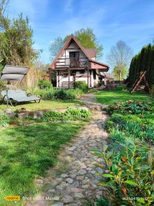 a home with a pathway leading to a house at Domek Kutowa in Kutowa