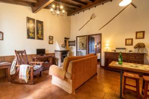 a living room with a couch and a table at La Casona del Cura 1, HORTENSIA in Palación