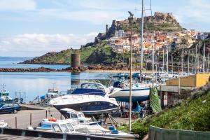 a bunch of boats docked at a marina with a hill at Best Western Hotel Blumarea in Castelsardo