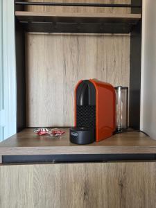 a toaster sitting on top of a wooden shelf at La Casetta al Lido in Alghero