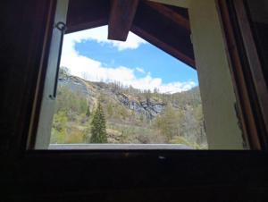 a view of a mountain through a window at Le chemin des étoiles in Evolène +12 photos