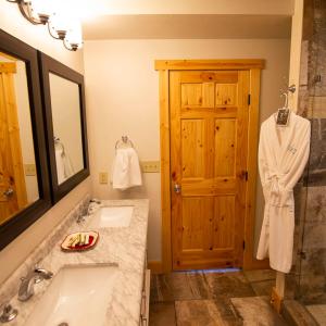 a bathroom with a tub and a sink and a mirror at Lilypad - by The Chalets in Logan +18 photos