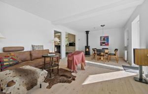 a living room with a couch and a table at 3 Bedroom Cozy Home In Rørvig in Rørvig
