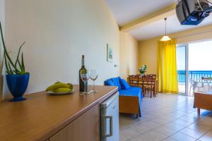 a kitchen and living room with a couch and a table at Atlantis in Plakias