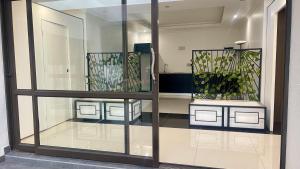 a display case with two potted plants in it at Central Perk Guesthouse in Pretoria