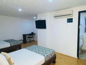 Voodi või voodid majutusasutuse Hotel Metropolis Plaza Cali toas