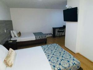 Voodi või voodid majutusasutuse Hotel Metropolis Plaza Cali toas