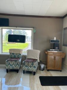 una sala de espera con 2 sillas y una ventana en Queen Elizabeth Motel, en Elizabeth City 7 fotos más