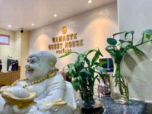 a statue sitting on a table in a store at Namaste Guest House in Pokhara