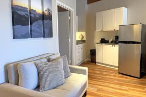 a living room with a couch and a refrigerator at Mountain Inn Studio 92 with Wintergreen Advantage in Wintergreen