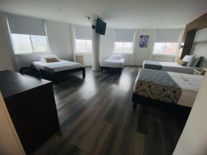 Voodi või voodid majutusasutuse Hotel Metropolis Plaza Cali toas