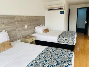 Voodi või voodid majutusasutuse Hotel Metropolis Plaza Cali toas