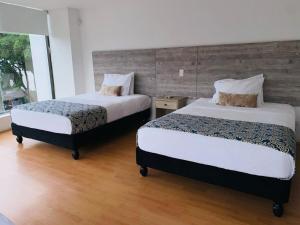 Voodi või voodid majutusasutuse Hotel Metropolis Plaza Cali toas