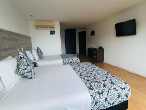 Voodi või voodid majutusasutuse Hotel Metropolis Plaza Cali toas
