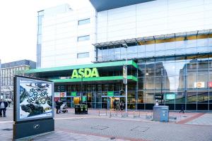 a large building with a sign in front of it at Stylish 1 bed Apt By Livra Estate Short Lets & Serviced Accommodation Sutton With Free Parking in Sutton