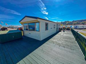 a tiny house on a boardwalk on a pier at Beachside Caravan Retreat In Lowestoft Sleeps 6 in Lowestoft