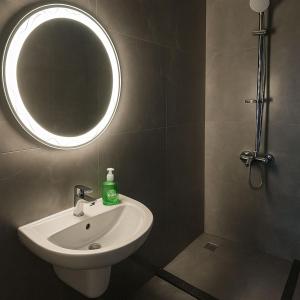 a bathroom with a sink and a mirror at Seaside Bliss Getaway in Port Said