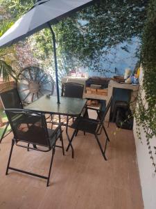 a table and chairs under an umbrella on a patio at Casa Montiel in Mérida