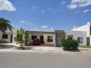 a house with a car parked in the driveway at Casa Montiel in Mérida