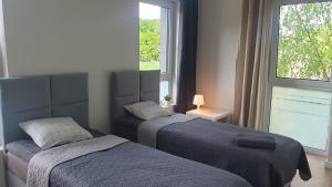 Łóżko lub łóżka w pokoju w obiekcie White Room Wrocław przy Wyspie Opatowickiej