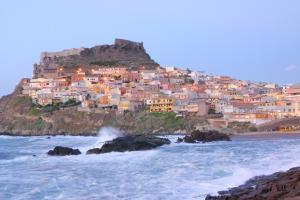 a town on a hill next to the ocean at Best Western Hotel Blumarea in Castelsardo