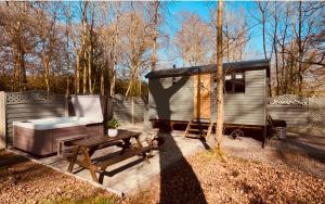 a small shed with a picnic table and a bench at Bodos’ Shepards Hut in Durham