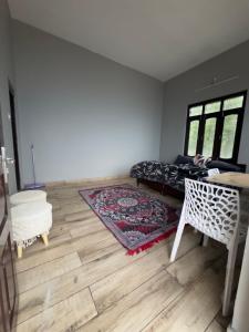 a living room with a couch and a rug at SamathaStay in Munsyari