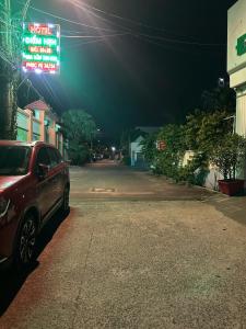 a car parked on the side of a street at night at Khách Sạn Điểm Hẹn in Ho Chi Minh City