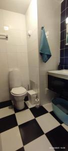 a black and white bathroom with a toilet and a sink at Tavira Downtown Calm House in Tavira +23 photos