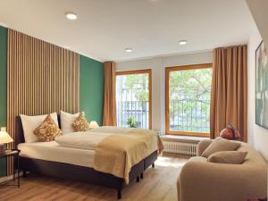 Кровать или кровати в номере Brunnen Apartments